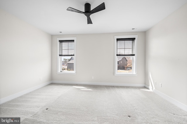 spare room featuring visible vents, baseboards, carpet, and a ceiling fan