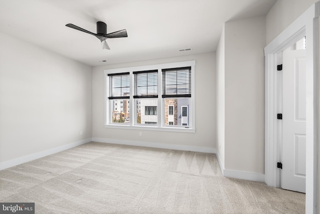 spare room with visible vents, baseboards, carpet, and ceiling fan