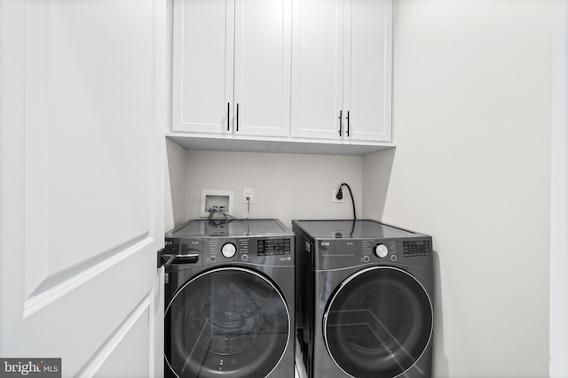 laundry area featuring cabinet space and washing machine and clothes dryer