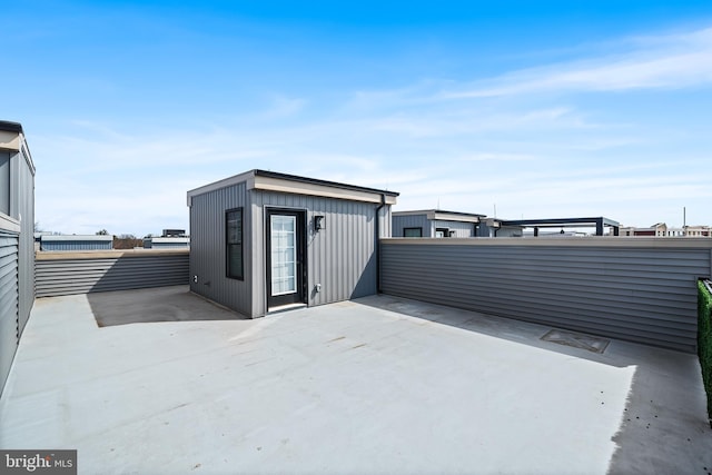 view of patio featuring an outbuilding