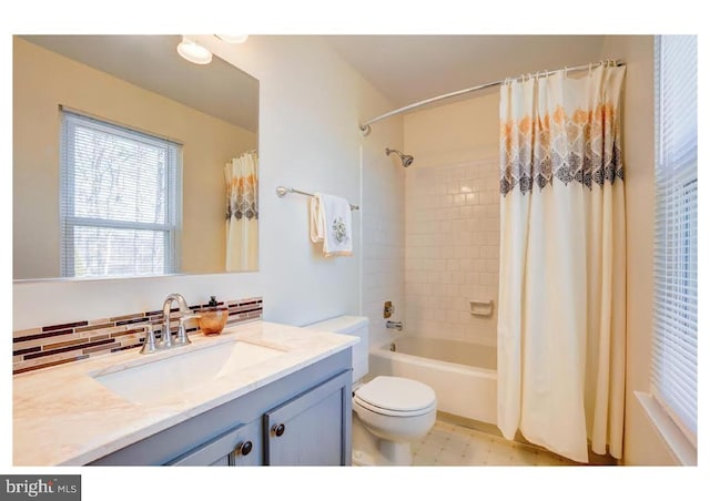 bathroom with backsplash, vanity, shower / bath combo with shower curtain, and toilet