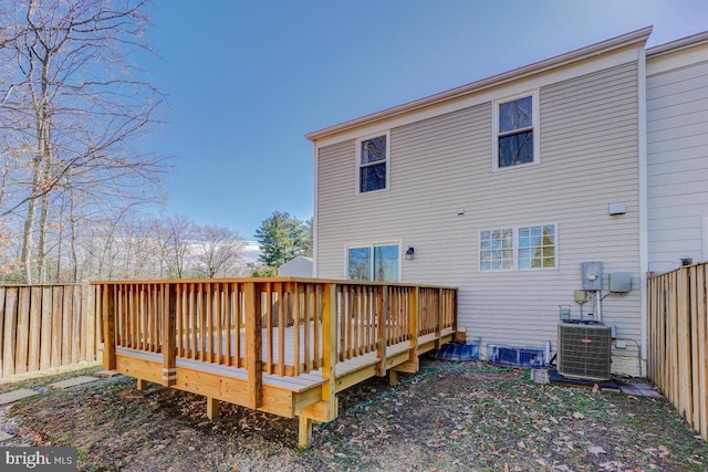 back of property featuring a deck, central AC, and fence