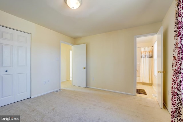 unfurnished bedroom featuring baseboards, a closet, and carpet floors