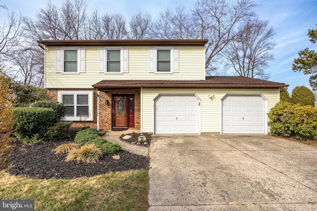 traditional-style home with a garage, brick siding, and driveway