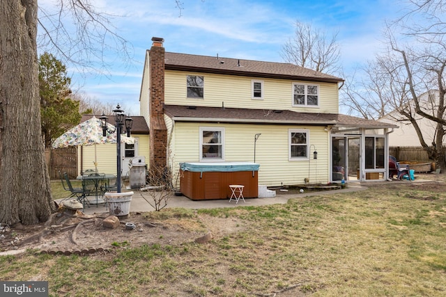 back of property with a patio area, fence, a sunroom, and a hot tub