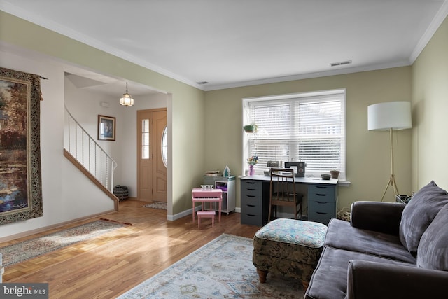 office space with visible vents, baseboards, wood finished floors, and ornamental molding