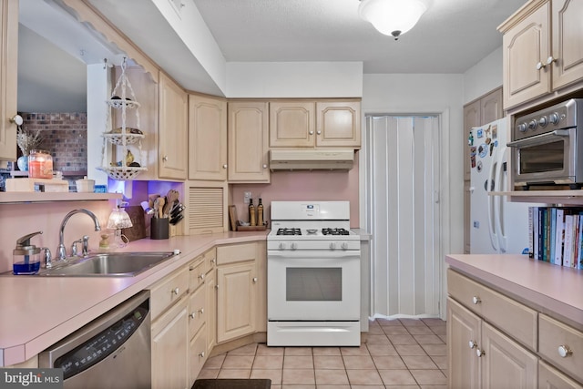 kitchen with a sink, light countertops, under cabinet range hood, and stainless steel appliances