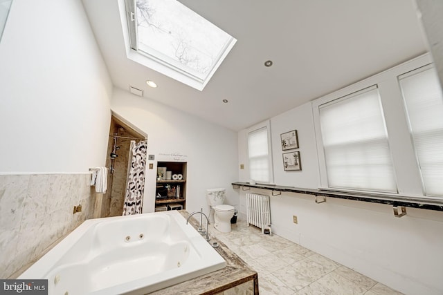 bathroom featuring a tub with jets, a skylight, radiator heating unit, curtained shower, and toilet