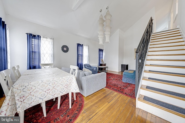 dining room featuring wood-type flooring and stairs