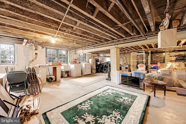 basement featuring washer and dryer and a sink