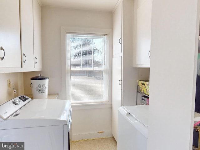 washroom featuring cabinet space and separate washer and dryer