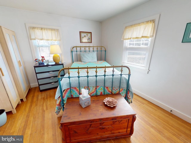 bedroom with baseboards and wood-type flooring