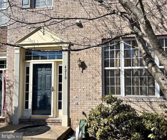 entrance to property with brick siding