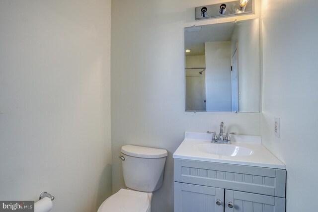 bathroom featuring toilet and vanity