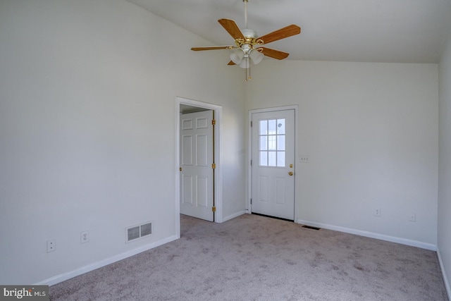 unfurnished room with vaulted ceiling, carpet flooring, baseboards, and visible vents