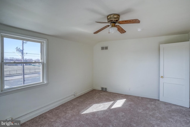 empty room featuring visible vents, baseboards, ceiling fan, and carpet floors