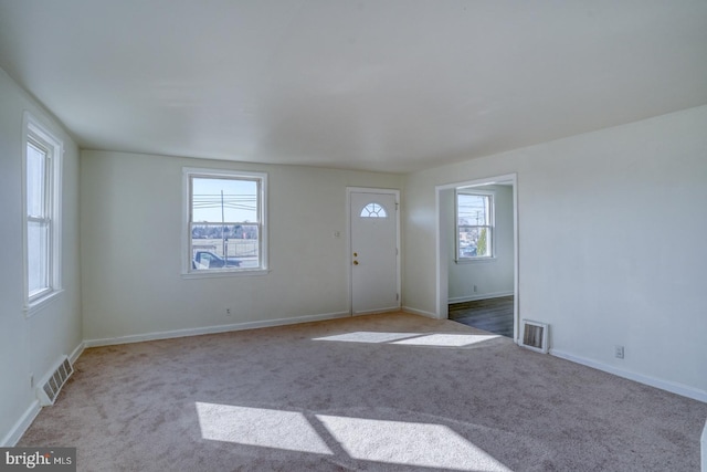 interior space featuring a wealth of natural light, visible vents, and baseboards