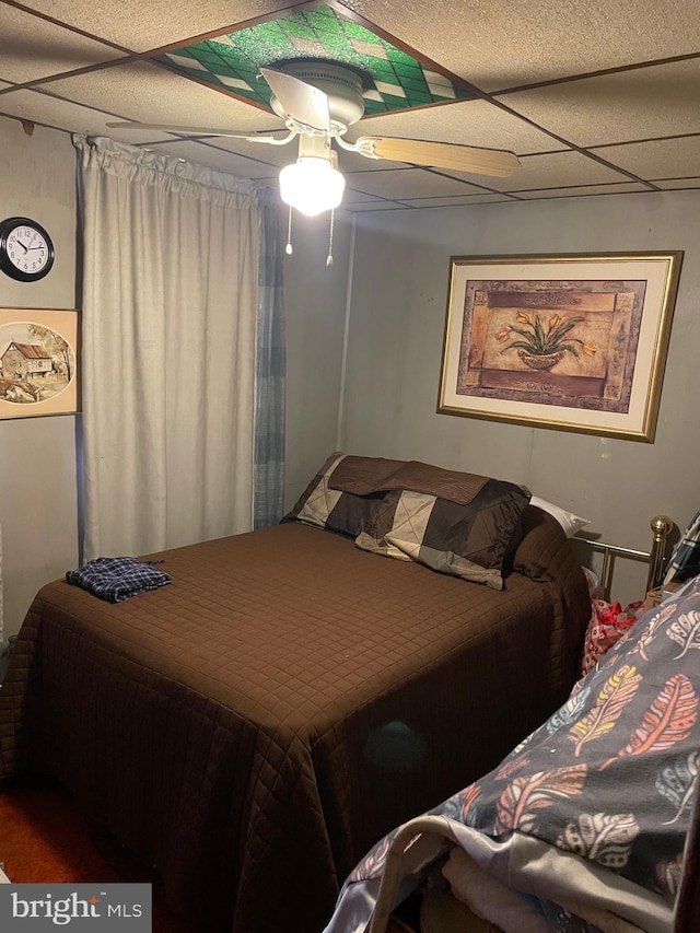 bedroom featuring a paneled ceiling and a ceiling fan