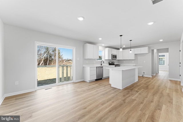 kitchen with light countertops, recessed lighting, appliances with stainless steel finishes, and a sink