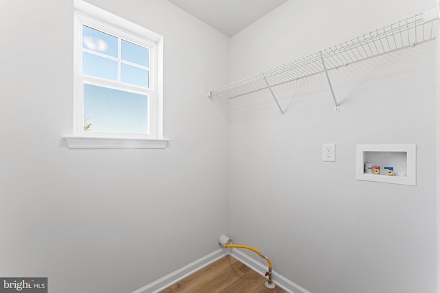 washroom featuring laundry area, hookup for a washing machine, wood finished floors, and baseboards