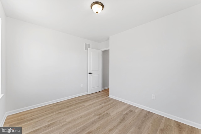 spare room with visible vents, baseboards, and light wood-style floors