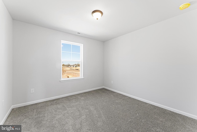 unfurnished room featuring visible vents, baseboards, and carpet floors