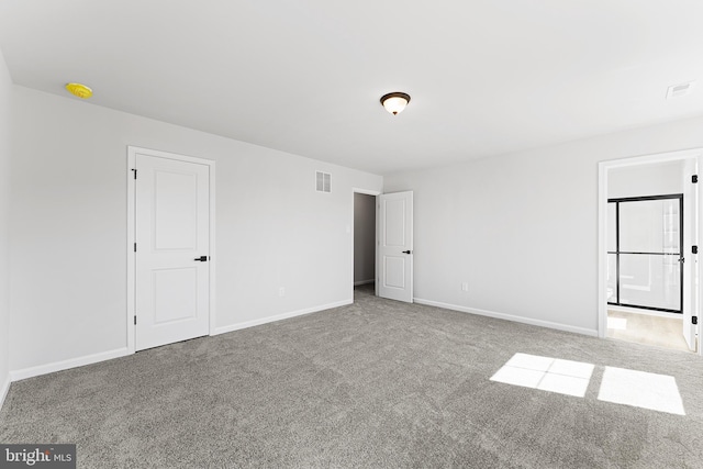 unfurnished bedroom with visible vents, baseboards, ensuite bathroom, and carpet