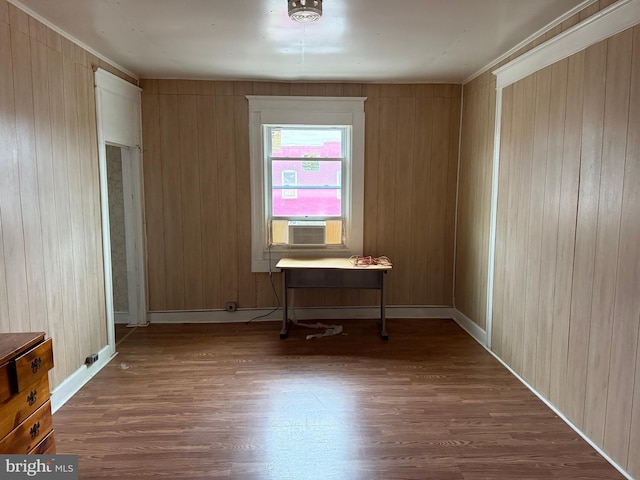 spare room featuring wood finished floors and baseboards