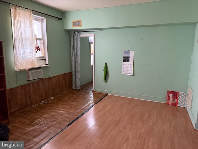 foyer featuring cooling unit and wood finished floors