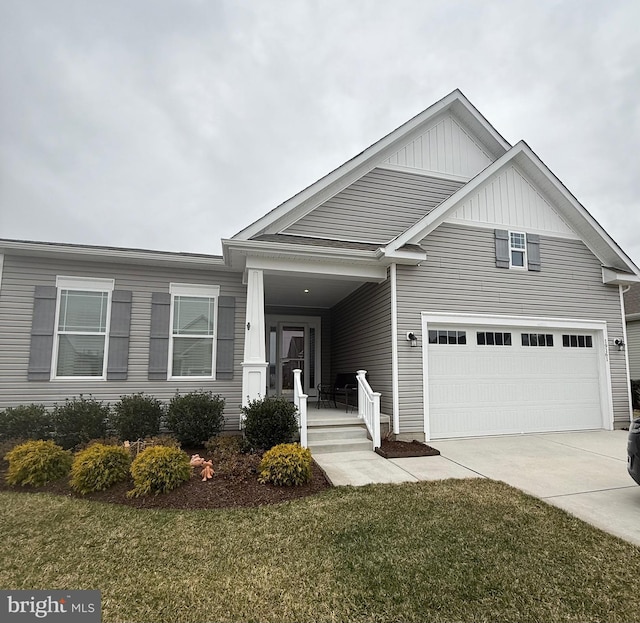 view of front facade featuring an attached garage, a porch, concrete driveway, and a front yard