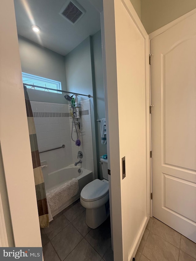 full bath with tile patterned floors, visible vents, toilet, and shower / bath combo