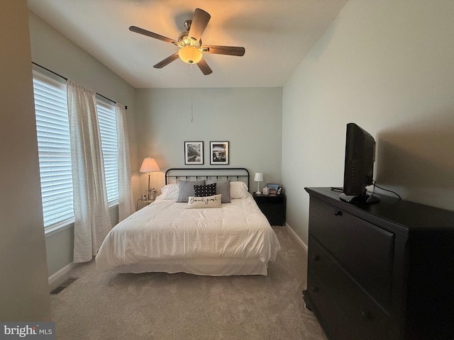 bedroom with visible vents, baseboards, carpet, and a ceiling fan