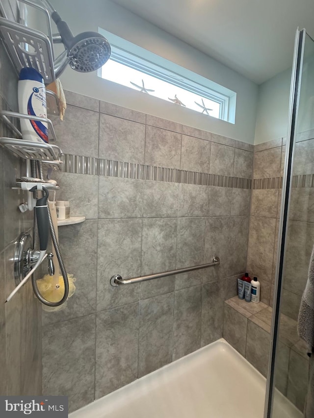 bathroom with tiled shower