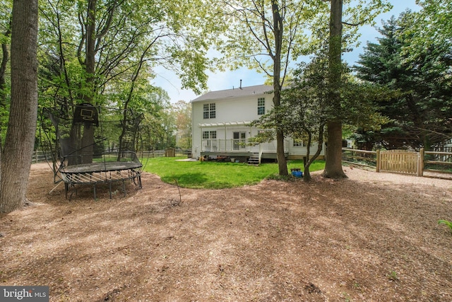 3106 Riverwalk Ct, Annapolis, MD 21403 - view of yard with a deck, a fenced backyard, and a trampoline