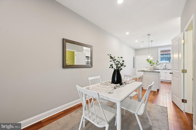 dining area with recessed lighting, baseboards, and hardwood / wood-style floors