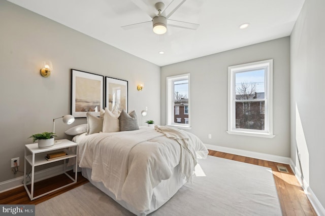 bedroom featuring visible vents, a ceiling fan, wood finished floors, recessed lighting, and baseboards