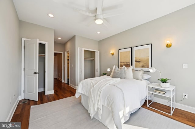 bedroom featuring a ceiling fan, recessed lighting, wood finished floors, and baseboards