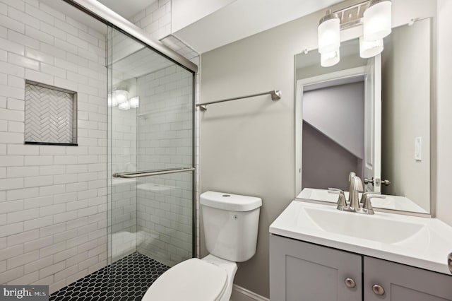 full bath with vanity, toilet, and a shower stall