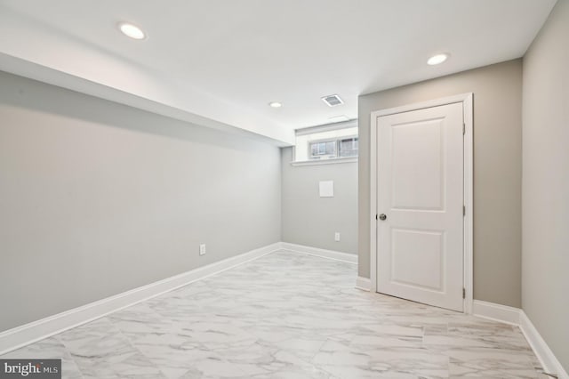 basement with recessed lighting, marble finish floor, visible vents, and baseboards