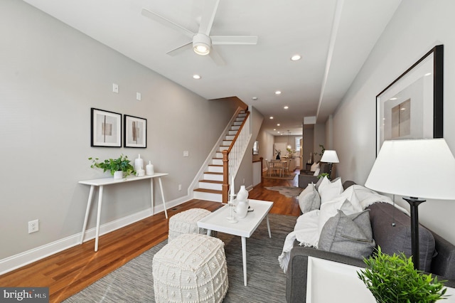 living room with baseboards, ceiling fan, stairway, recessed lighting, and wood finished floors