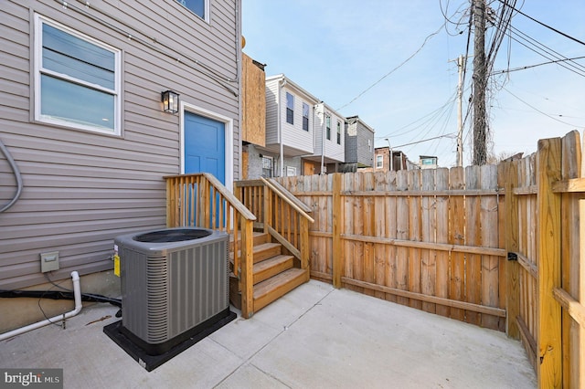 view of patio featuring cooling unit and fence