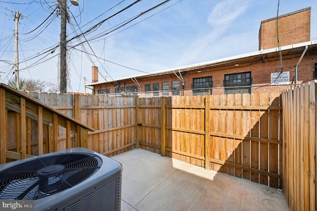 view of patio featuring central air condition unit and fence