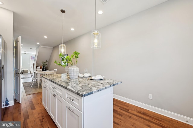 kitchen featuring recessed lighting, white cabinets, a kitchen island, and dark wood-style flooring