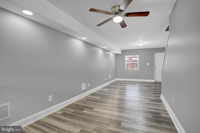 unfurnished room featuring wood finished floors, visible vents, baseboards, recessed lighting, and ceiling fan