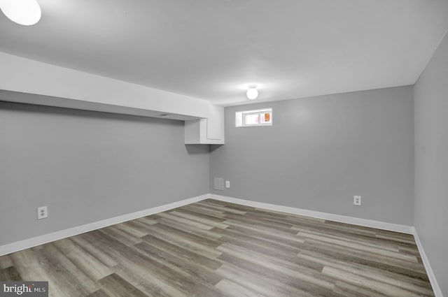 below grade area with wood finished floors and baseboards