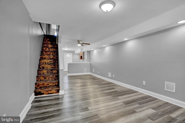 basement with stairway, wood finished floors, visible vents, and baseboards