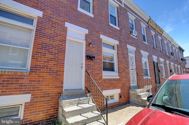 exterior space featuring cooling unit and brick siding