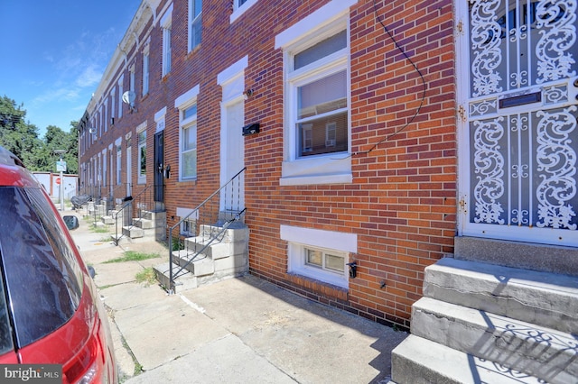 exterior space with brick siding and entry steps