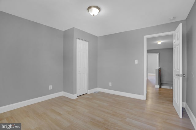 unfurnished room featuring light wood-style floors and baseboards