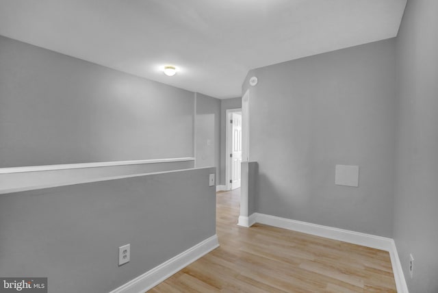 empty room with wood finished floors and baseboards